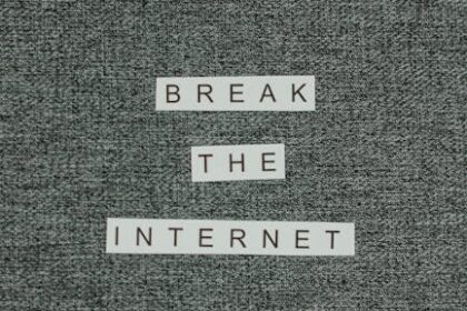 Close-up shot of the phrase 'Break the Internet' on textured fabric background.